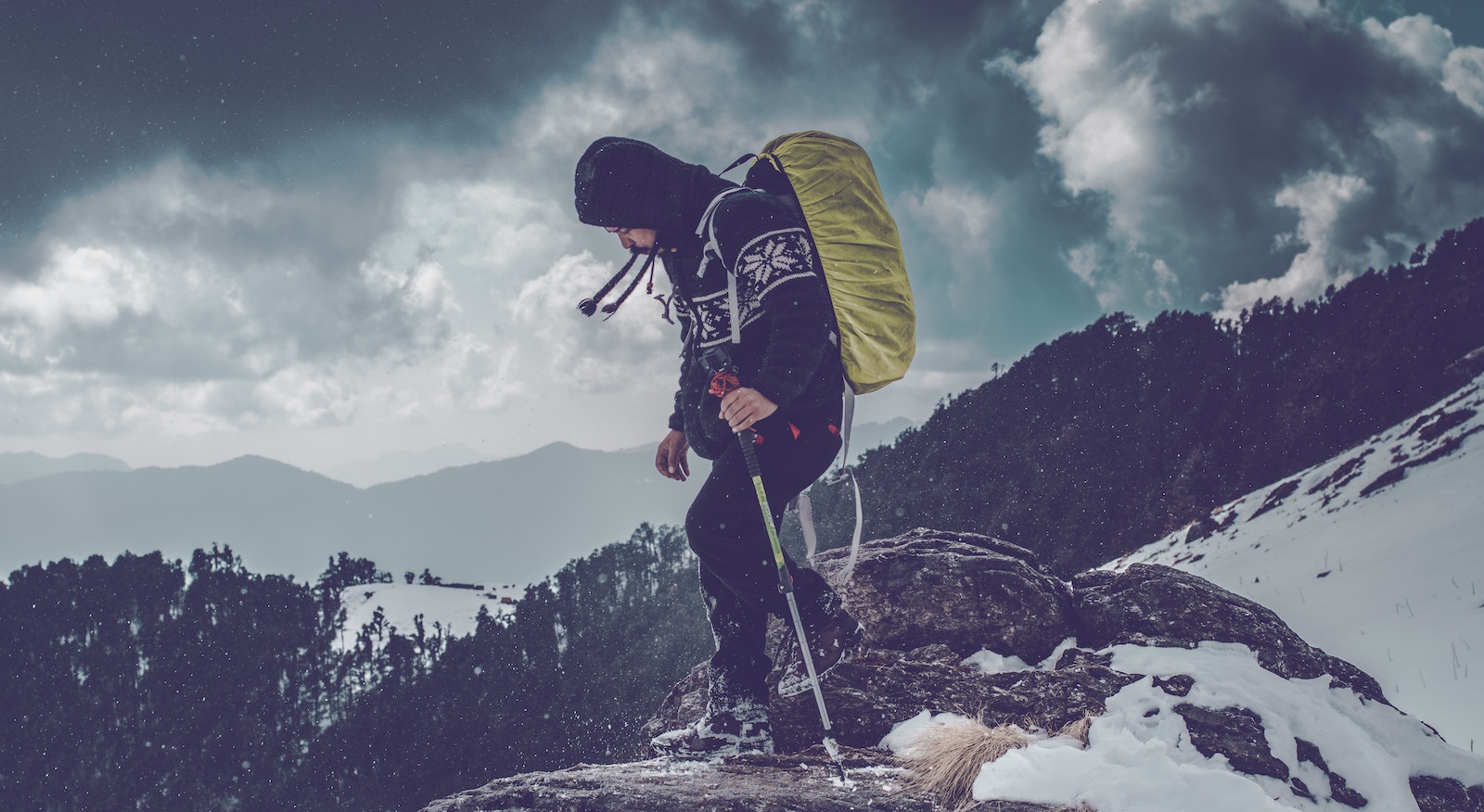 Man Wearing Black Hoodie on Rock Edge