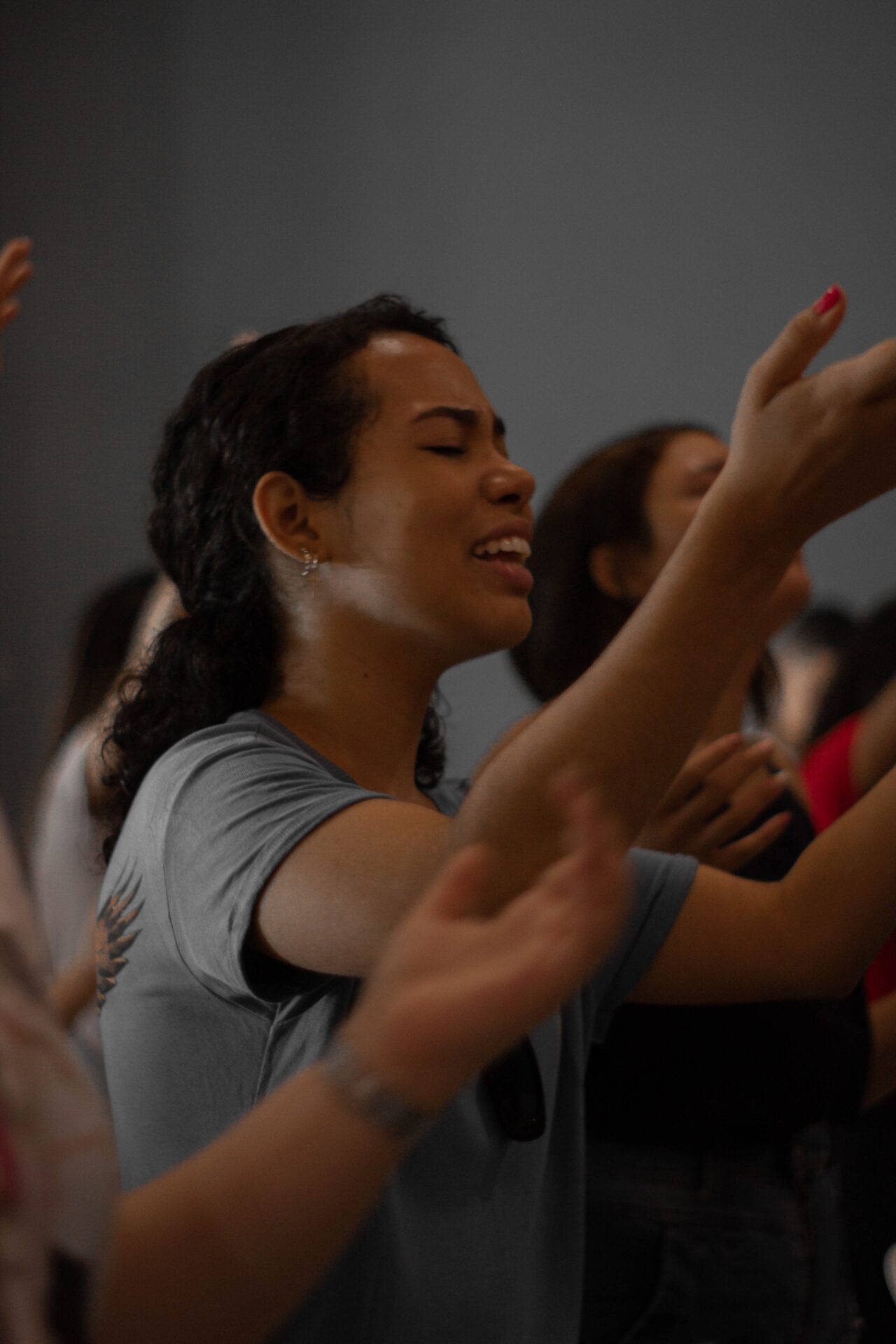 Close-Up Shot of a Woman in Gray Shirt Worshipping
