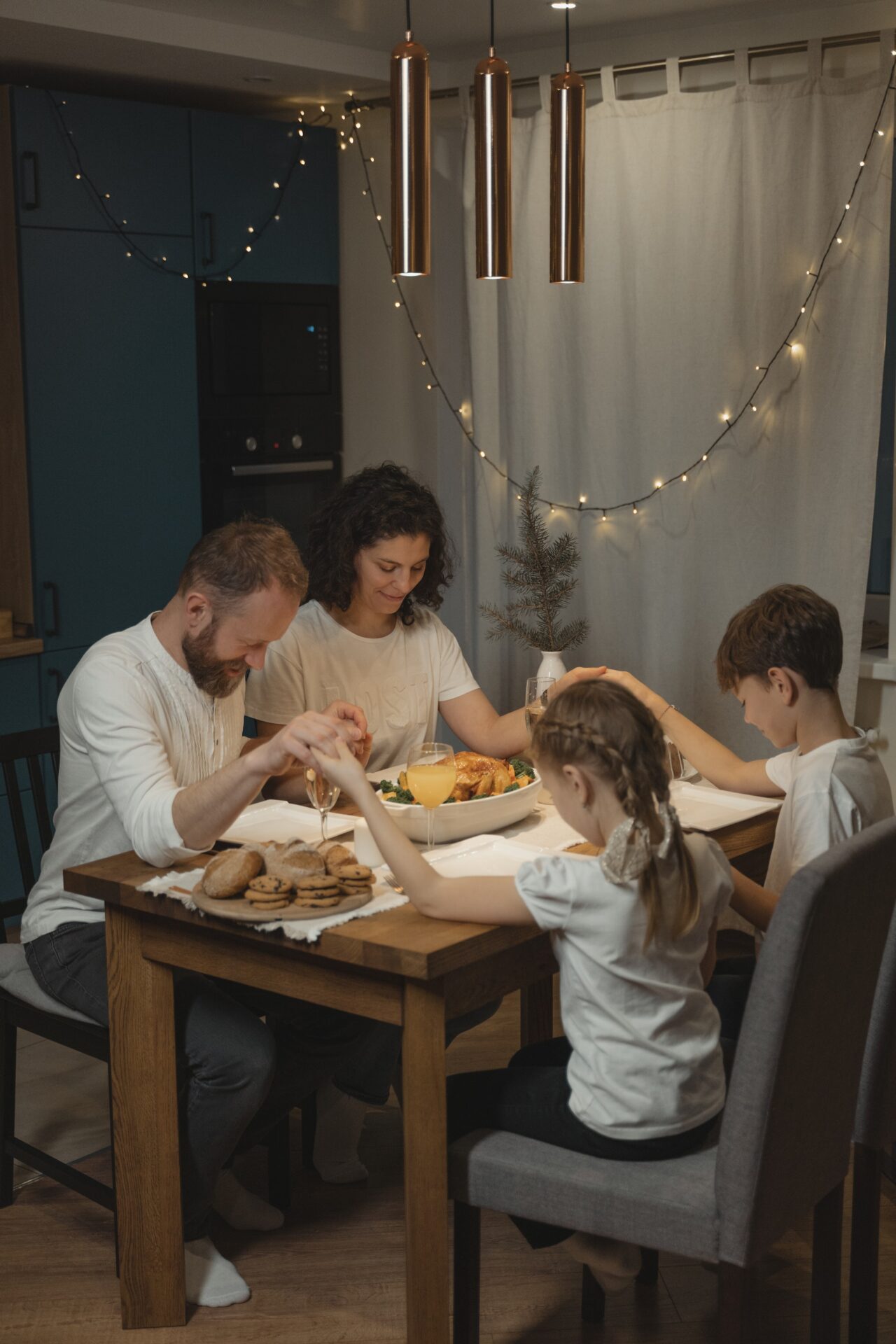 A Family Holding Hands in Reciting a Prayer