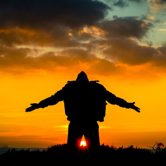 silhouette of man spreading its arm