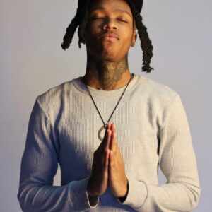 Young Man Putting His Hands Together to Pray and Standing with Eyes Closed