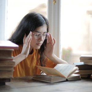 A Weary Female Student Having a Headache