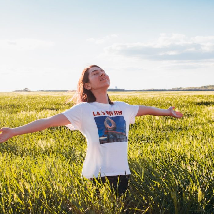 woman standing in green field