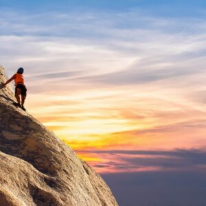 Person Climbing on Mountain