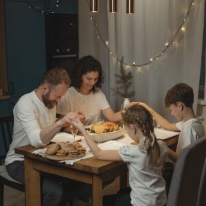 A Family Holding Hands in Reciting a Prayer