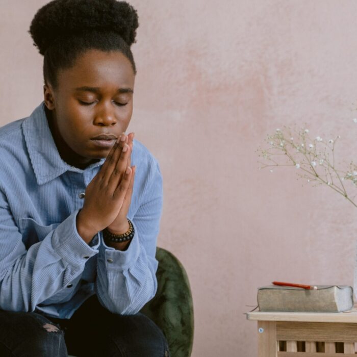 Woman in Blue Dress Shirt Praying