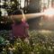 girl sitting on daisy flowerbed in forest