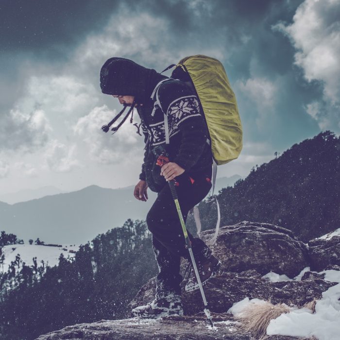 Man Wearing Black Hoodie on Rock Edge