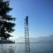 boy on ladder under blue sky