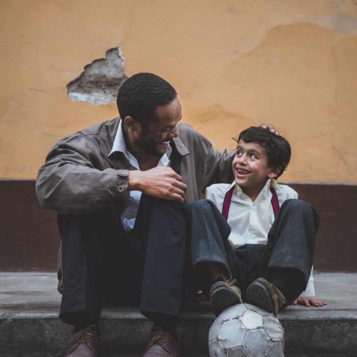 man holding boy's head