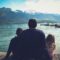 man and woman sitting on brown wooden dock during daytime