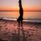 person near body of water during golden hour