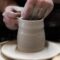 person holding round white ceramic bowl