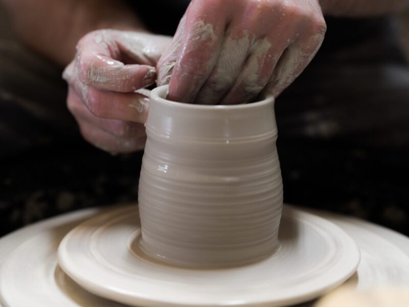 person holding round white ceramic bowl