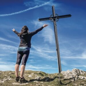 a person standing next to a cross