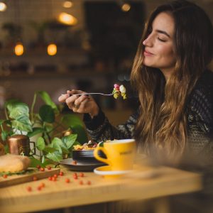 woman holding fork in front table