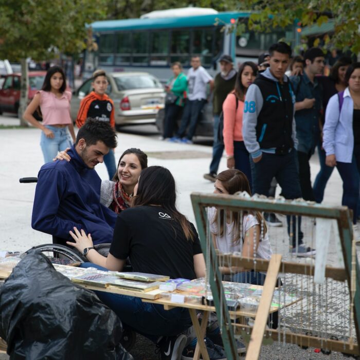 people sitting on brown wooden bench during daytime