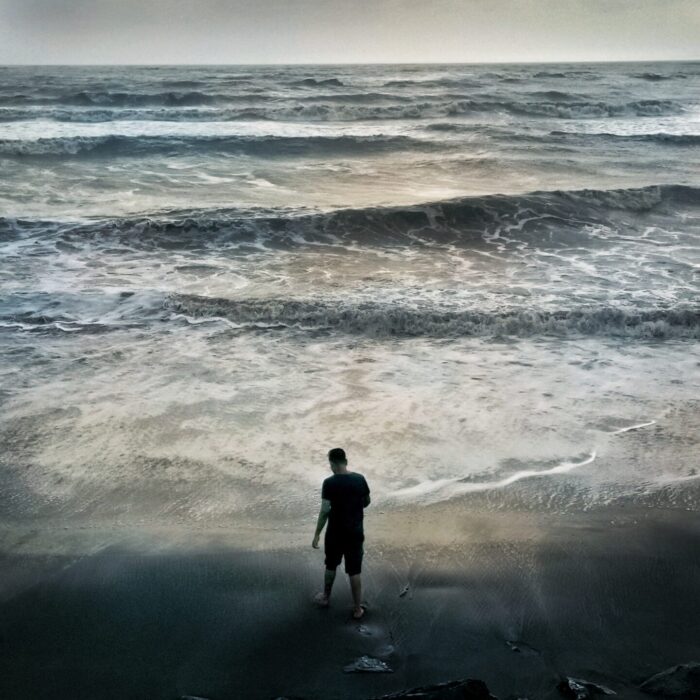 2 person standing on seashore during daytime