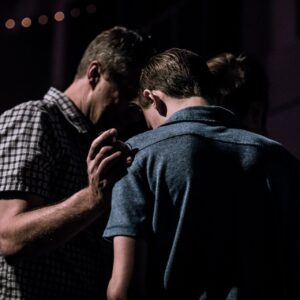 men touching each other's foreheads