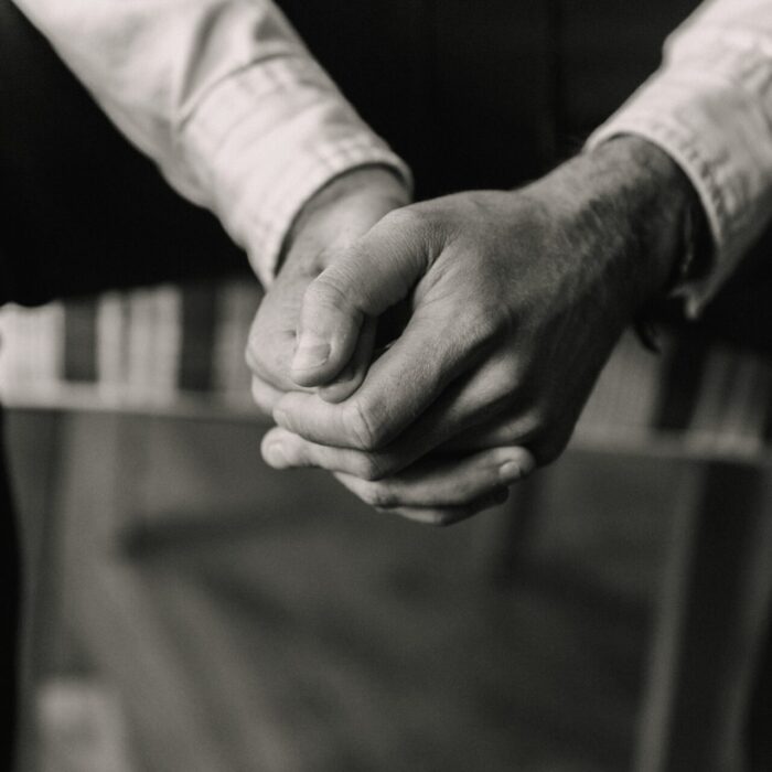 grayscale photo of man and woman holding hands