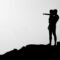 silhouette of man carrying child