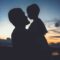 silhouette of man and woman kissing during sunset